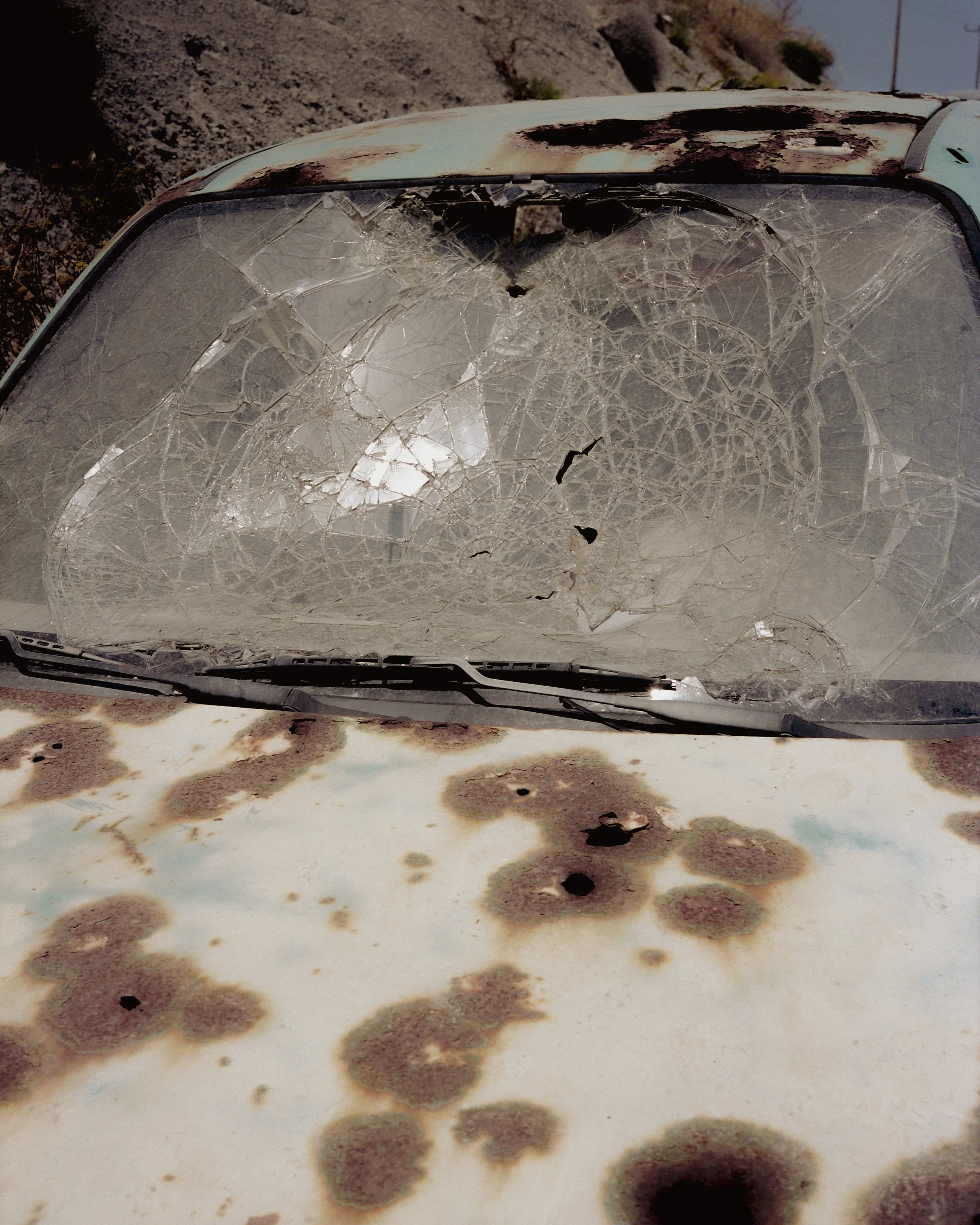 old rusty car with smashed windscreen