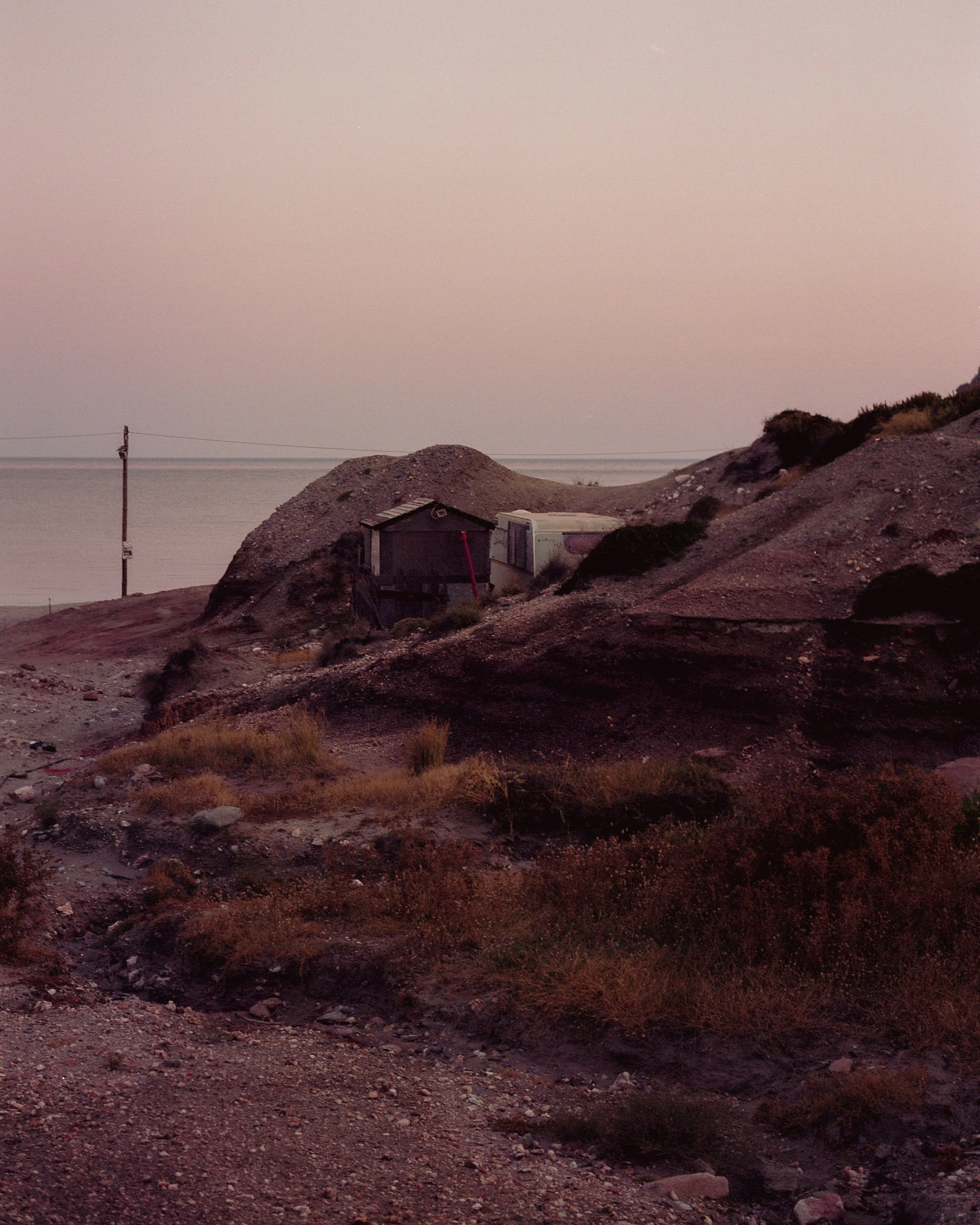 deserted caravan on beach in milos