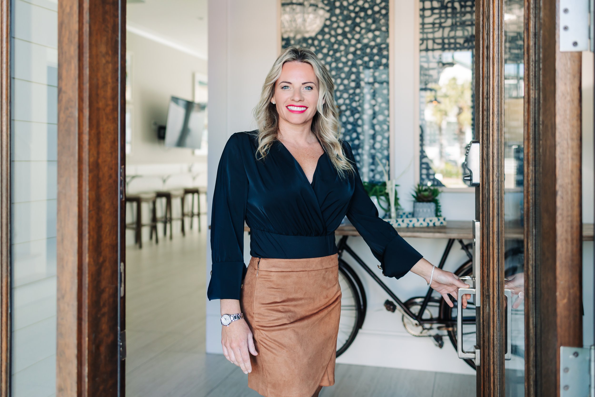Heather Blatz, Emerald Coast real estate broker, welcoming clients at a home