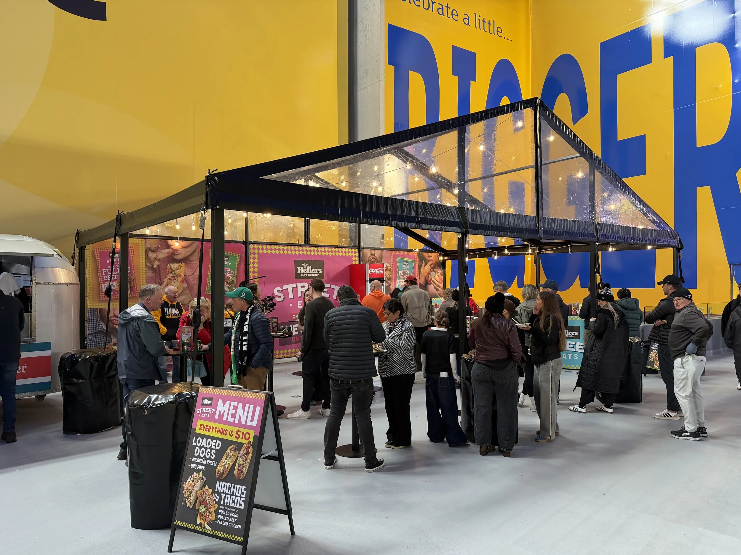 Black frame clear marquee hosting guests at a corporate brand activation