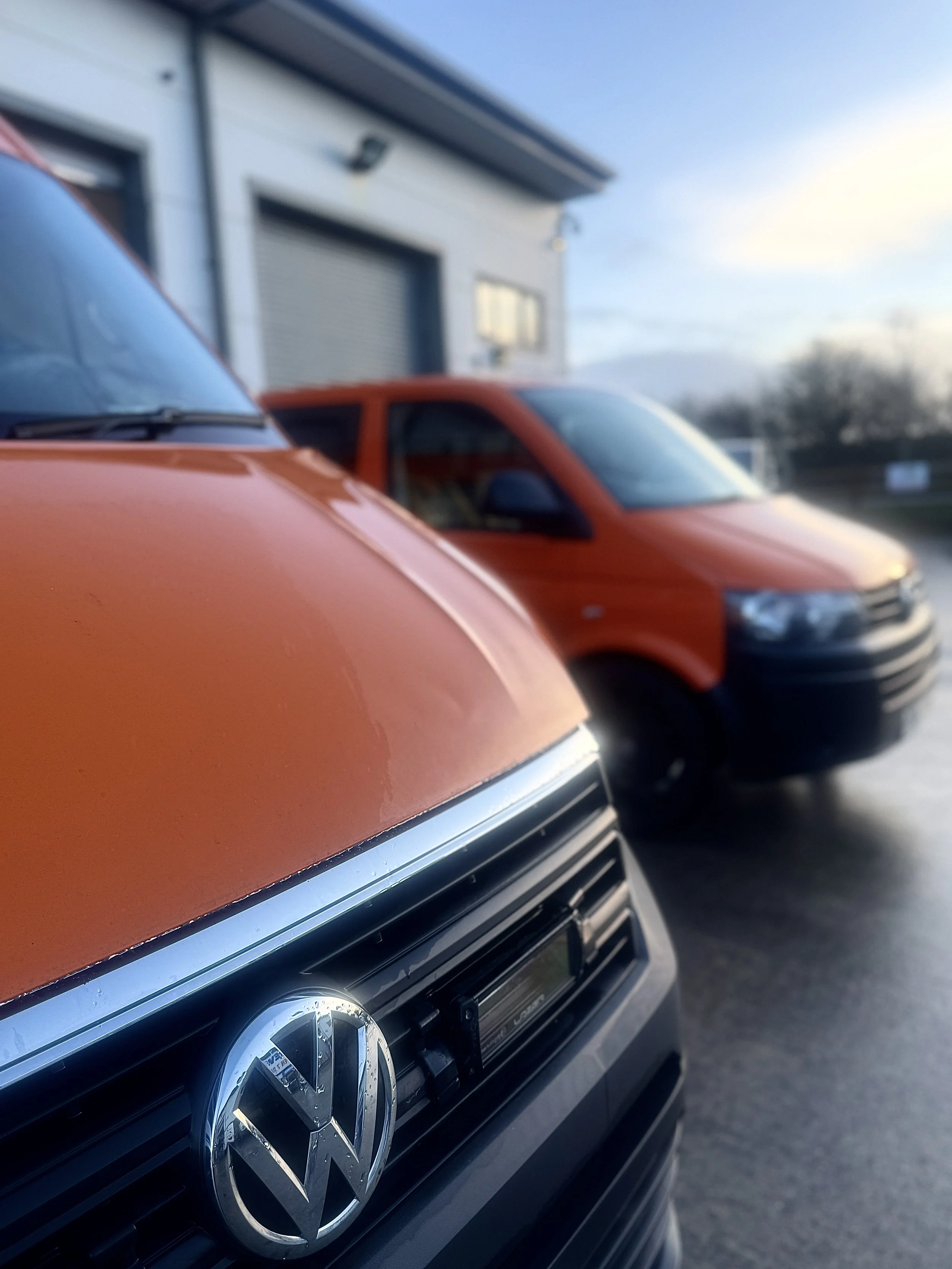 Orange VW Crafter campervan alongside a VW Transporter | VW Crafter for sale | Cornwall