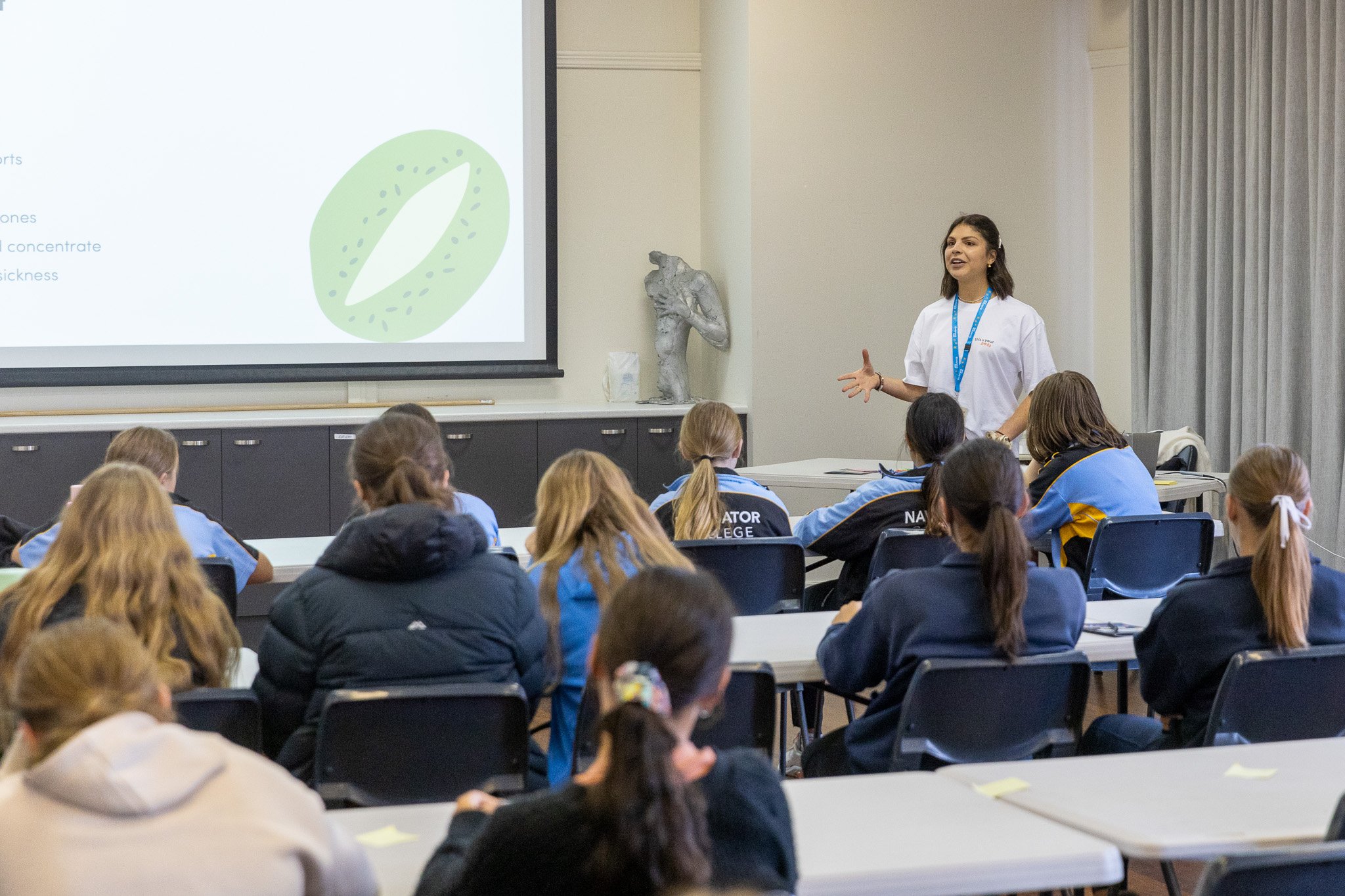 Gel presenting to a class of Year 7 students