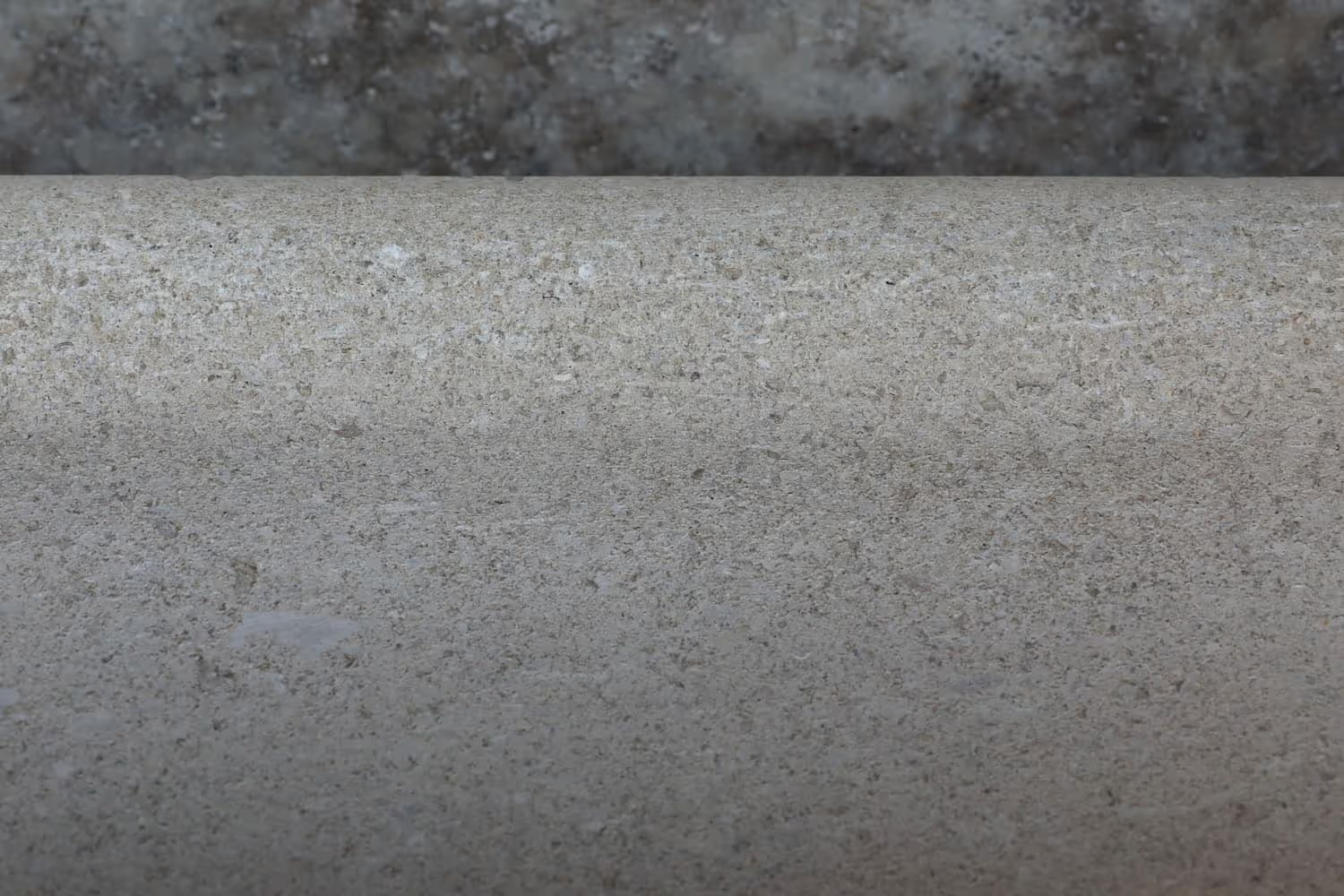 Close-up of a textured concrete surface with a darker background.