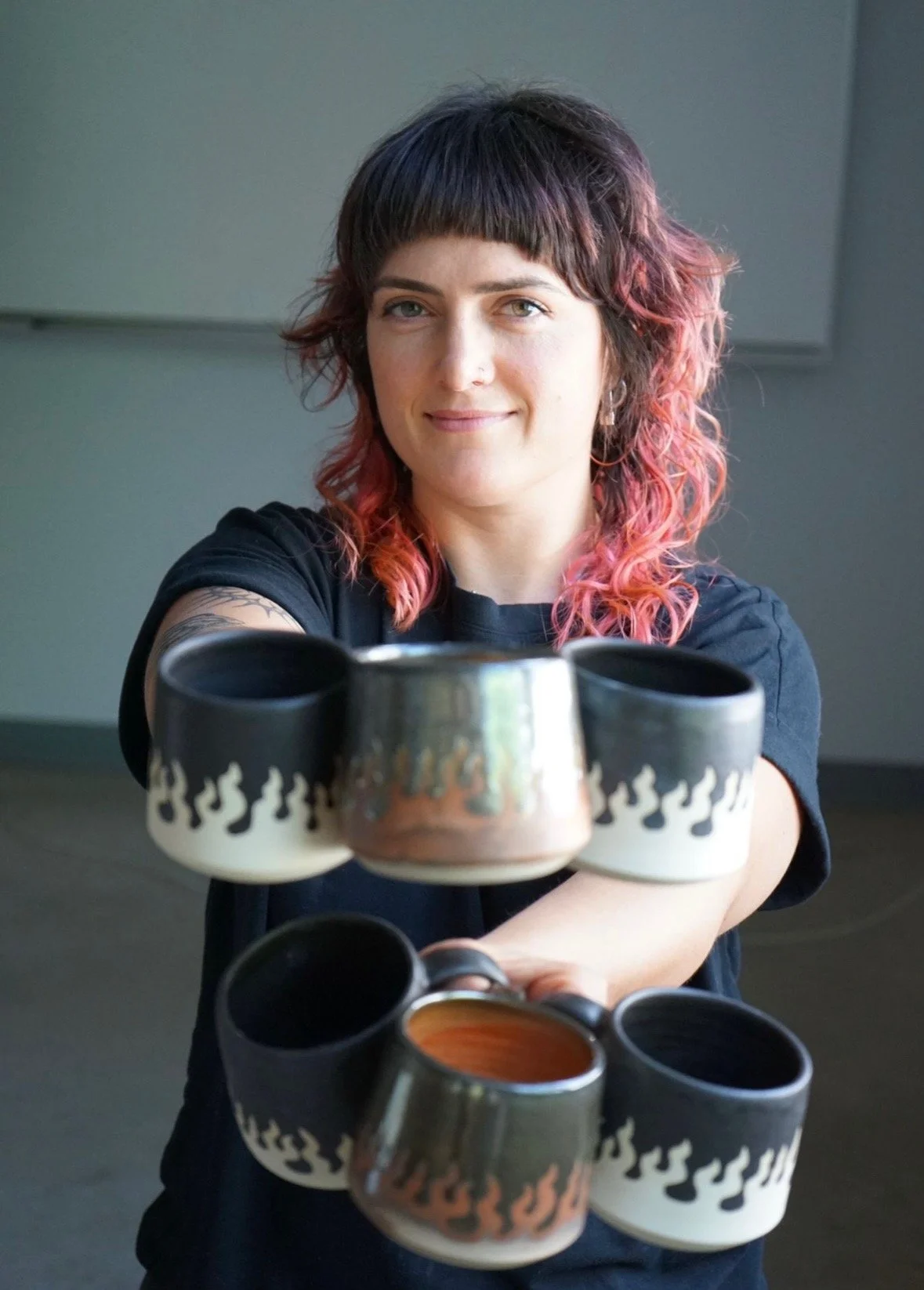 potter and ceramic designer sitting at a pottery wheel at mud ceramics club in nelson bc