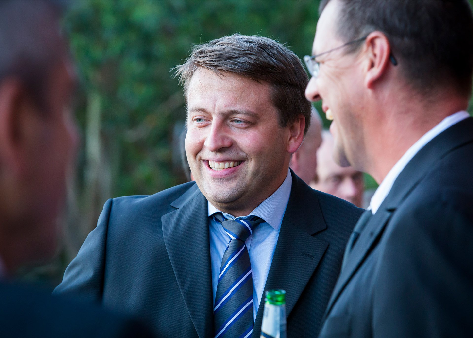  three men in suits networking smiling drinks brisbane kirsten cox photographer event 