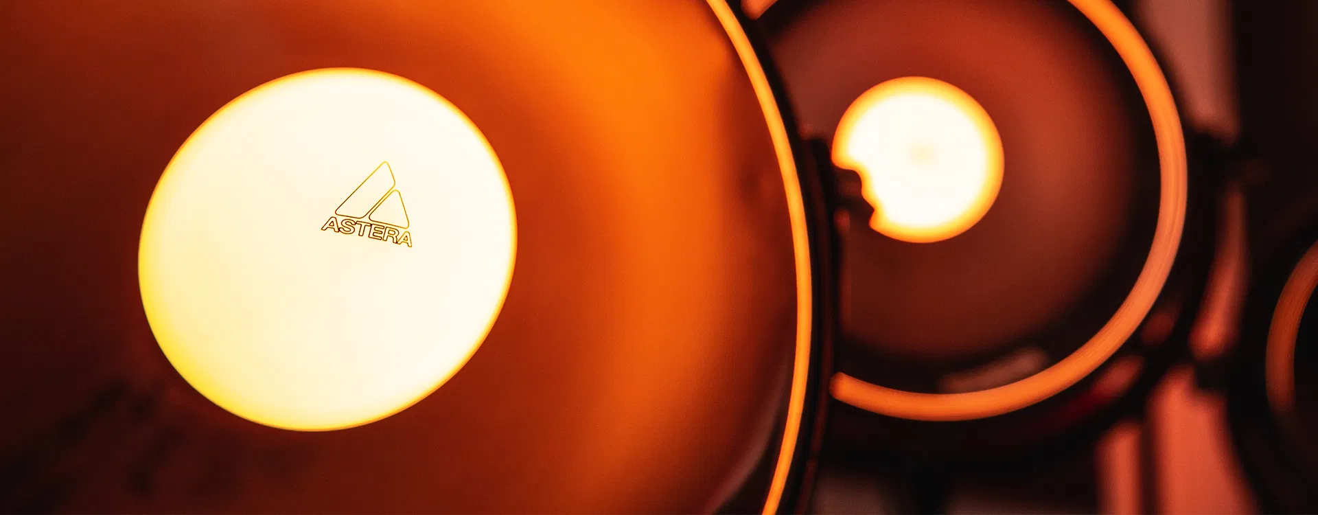 Astera NYX Bulbs glowing warm yellow in a row