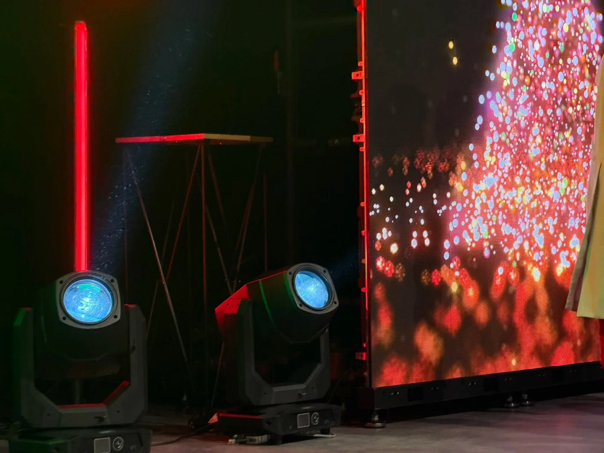 EK H1 moving head lights delivering punchy beams beside an LED wall, available for professional lighting hire on the Sunshine Coast, Brisbane and Sydney.