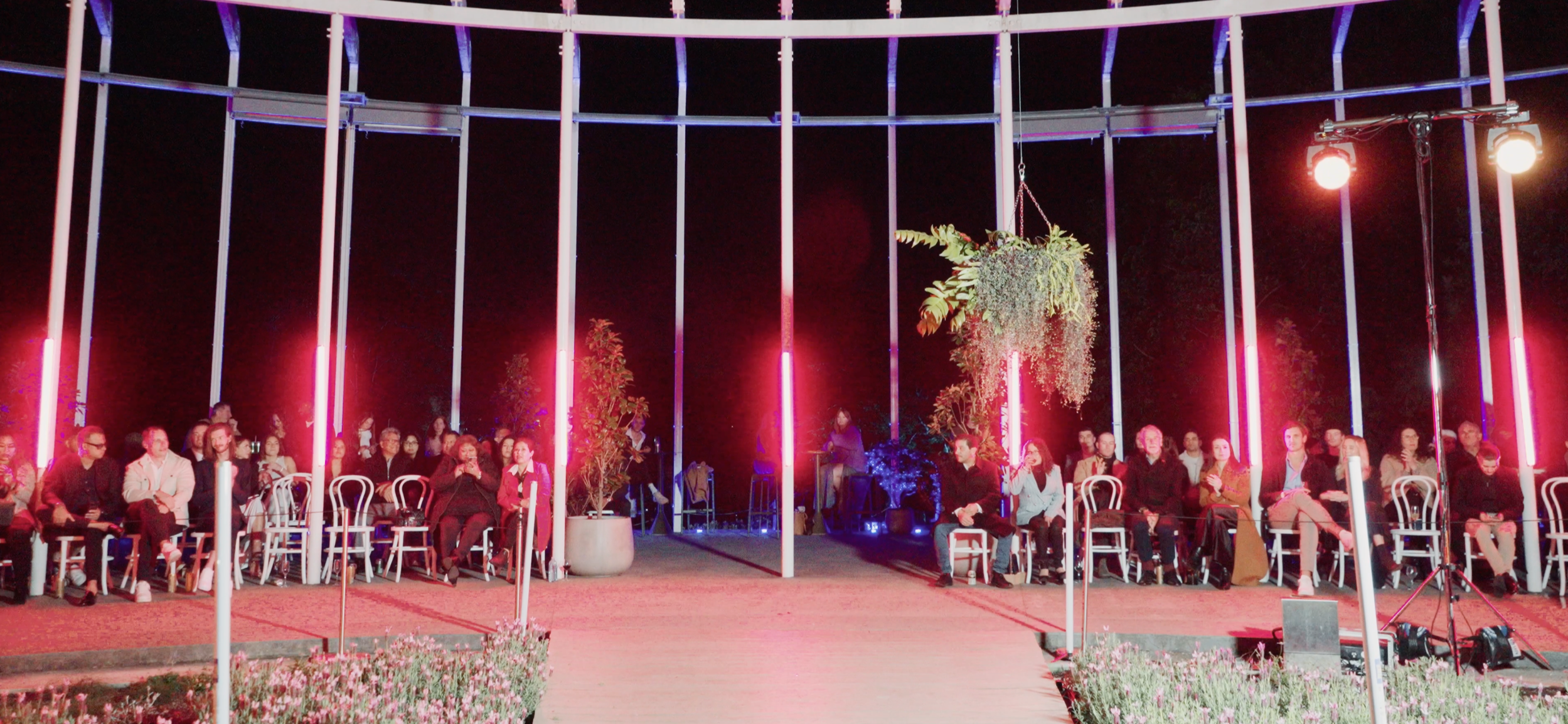 Fashion runway at The Calyx Sydney Botanic Garden lit with vertical LED tube lighting, creating architectural colour accents for a live audience, showcasing premium lighting design and professional lighting hire for events in Sydney and Brisbane