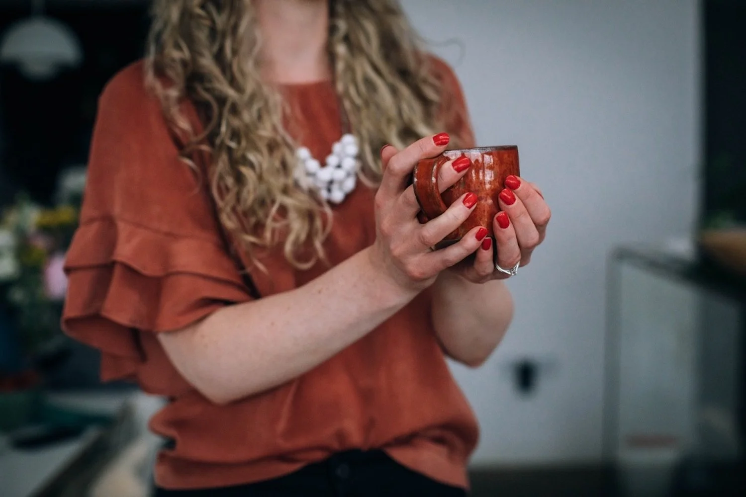 Mary holding a cup of tea.