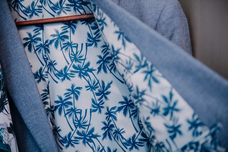 Hawaii Motto Hochzeit beim Fuschlsee im Salzkammergut in der Hochzeitslocation Ansitz Wartenfels am Berg. Claudia Weaver fotografiert das Getting Ready, d.h. die Vorbereitung des Brautpaares in der Hochzeitssuite. Anzugs und Brautkleid Fotos.