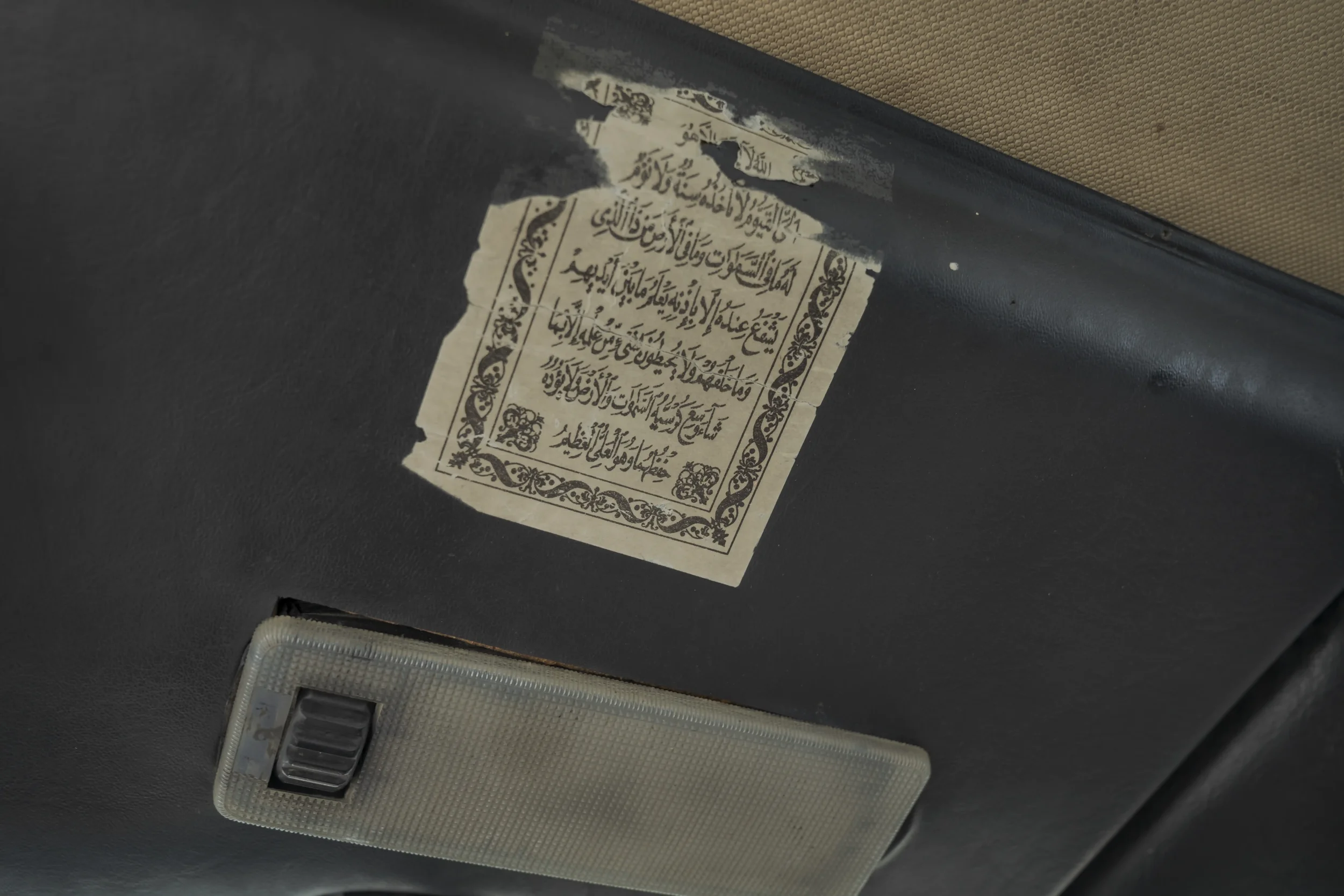 A Quranic verse hangs from the dashboard. In a landscape of uncertainty, the cabin becomes an intimate space of protection.
Ramallah - November 2025