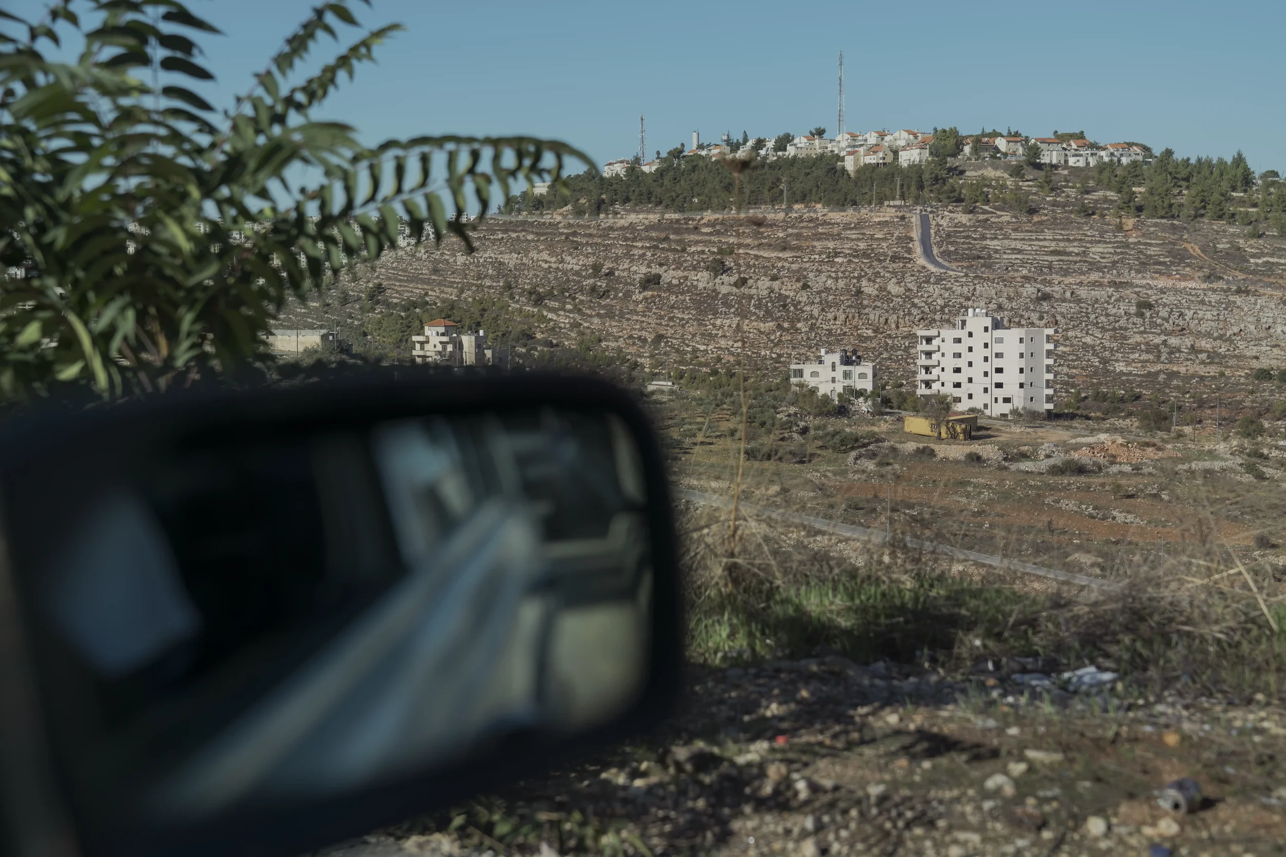 From Khaldon’s Mercedes window, the Psagot settlement rises beyond a Ramallah hill — a landscape where physical proximity contrasts with functional separation.
Ramallah - November 2025