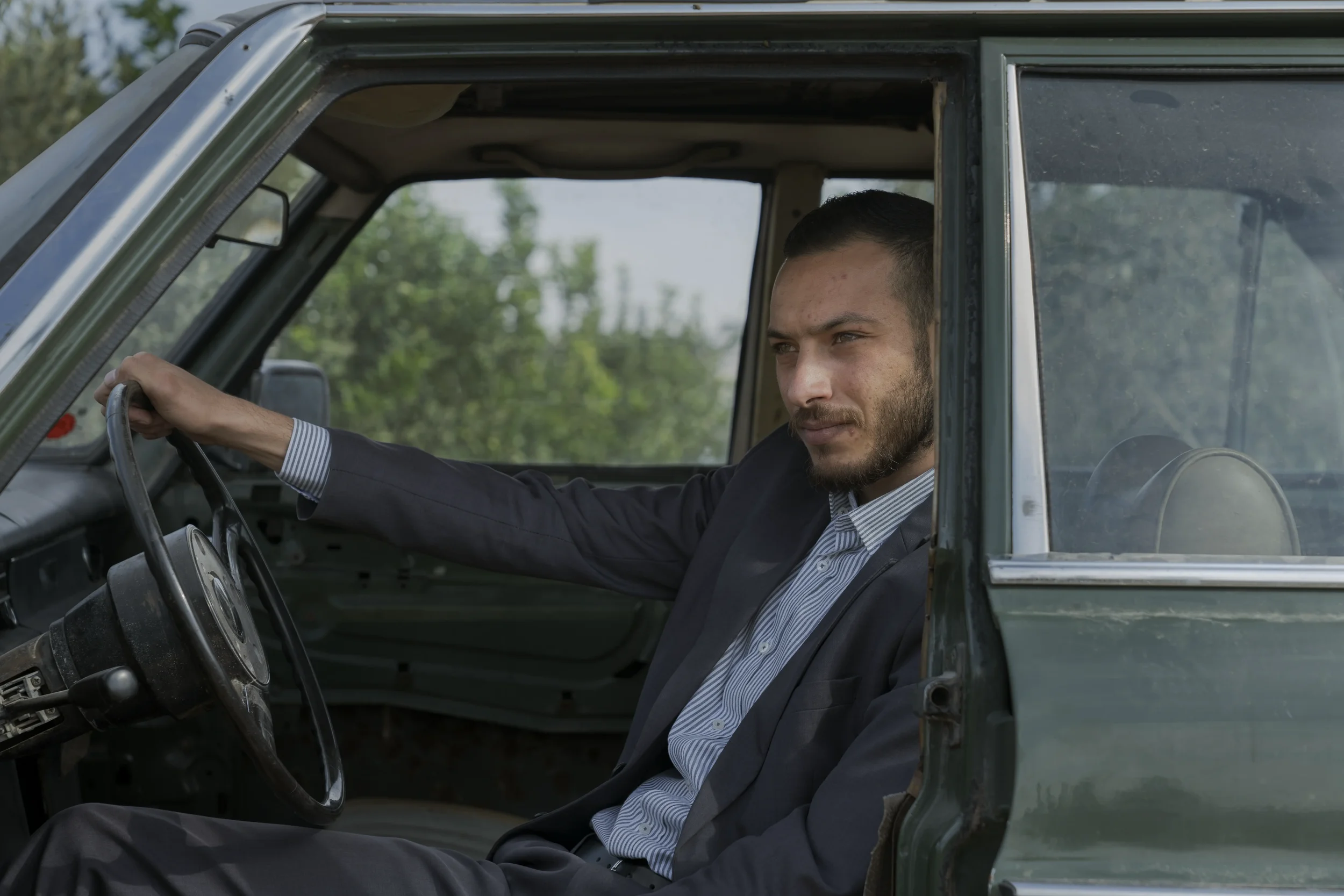 Qassam, 24, a lawyer, sits inside his Mercedes inherited from his grandfather, who worked for
decades as a border taxi driver between Jordan and Lebanon. The main road to his village is now reserved for settlers, forcing him to take long detours and 