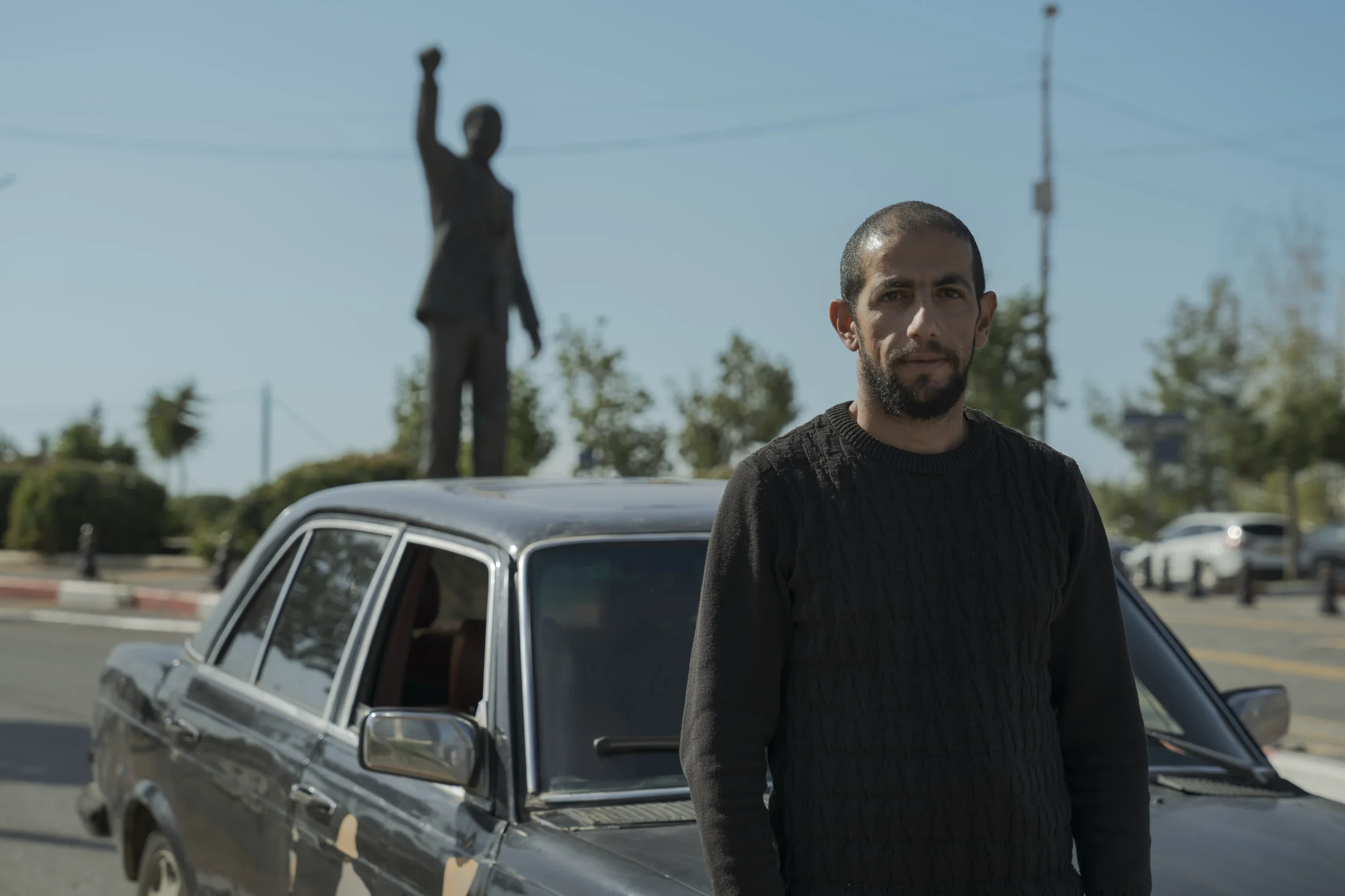 Khalil, a driver from Ramallah, stands beside his car in Nelson Mandela Square.
The statue behind him evokes a global legacy of struggles that many Palestinians see reflected in their own restricted mobility.
Ramallah - November 2025