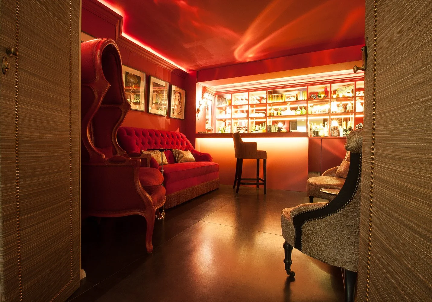 Private home bar with red lighting and tufted sofa, interior photography Chelsea