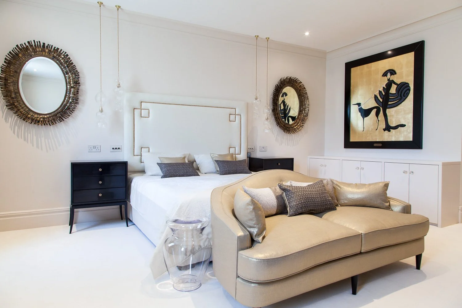 Master bedroom with art deco wall art, sunburst mirrors and gold-toned sofa, interior photographer London, Clapham