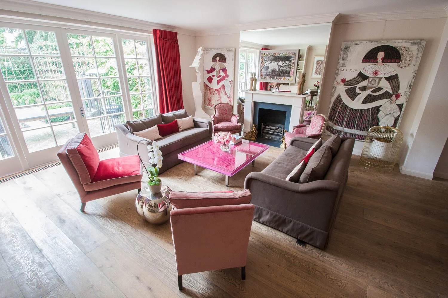 Living room with pink velvet armchairs and gallery wall artwork, interior photographer, Chelsea