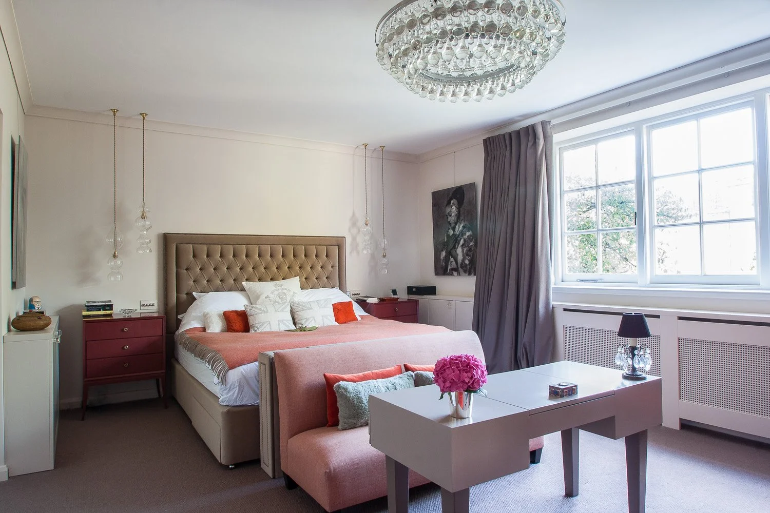 Bedroom with tufted headboard, chandelier and pink accent bench, interior design photographer London, Chelsea