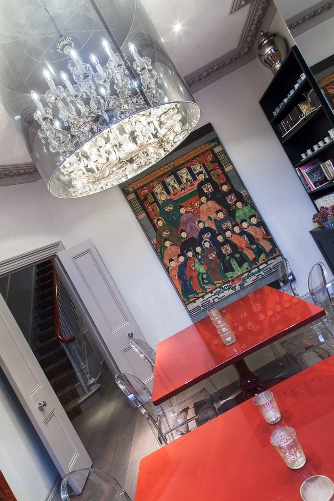 Landing with crystal chandelier, tapestry artwork and glass-topped console table, interior design photography, Chelsea