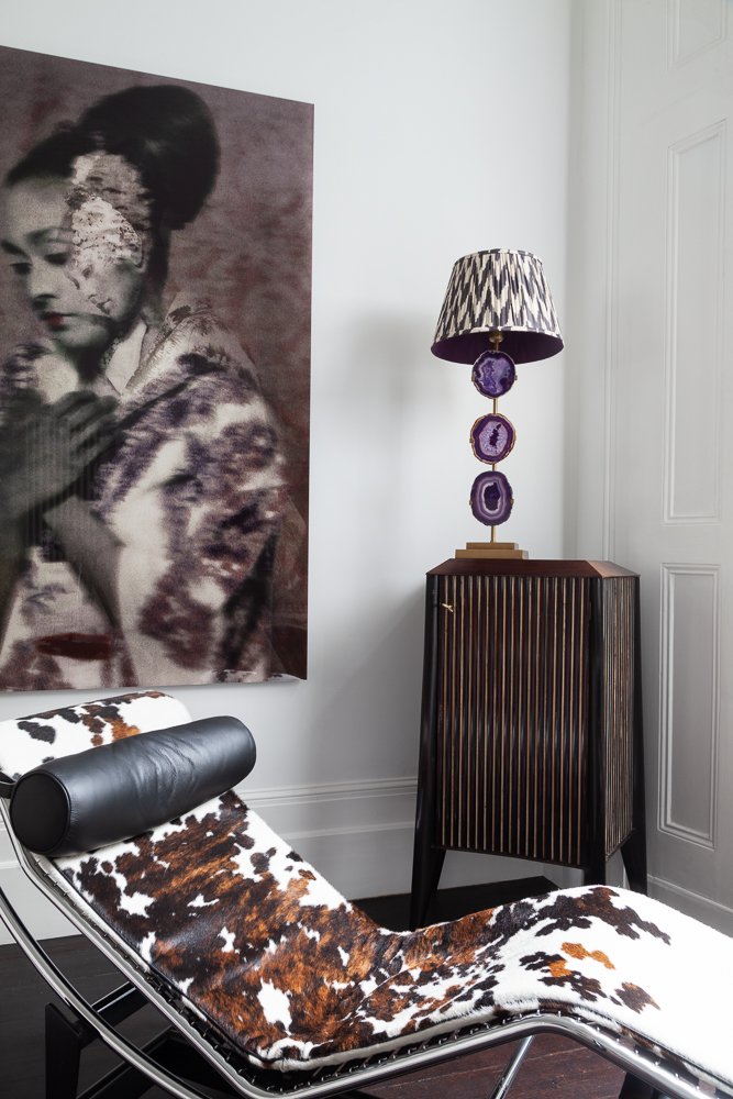 Living space with statement artwork, leather chaise longue and sculptural floor lamp, interior design photographer London, Clapham