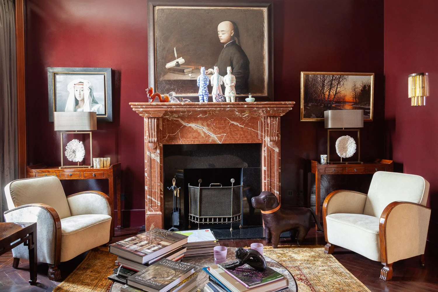 Sitting room with marble fireplace, cream armchairs and gallery wall portraits, interior photographer London, Clapham