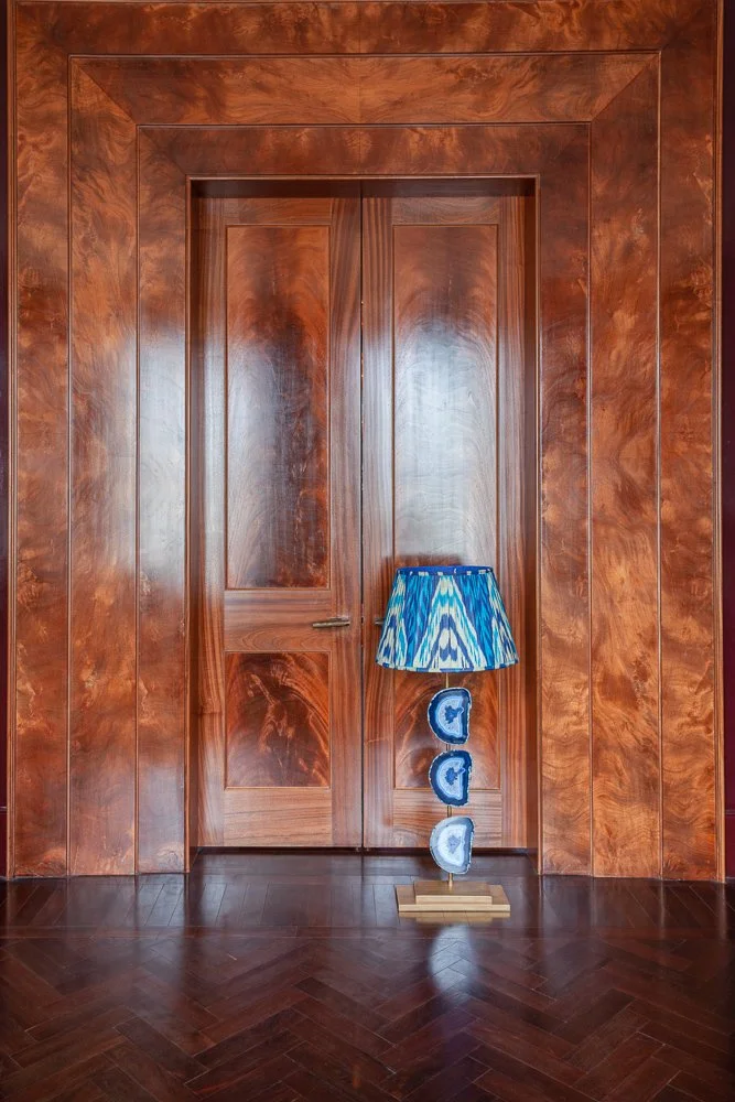 Isabelle Bizard floor lamp beside a wood-panelled door, interior design photographer London