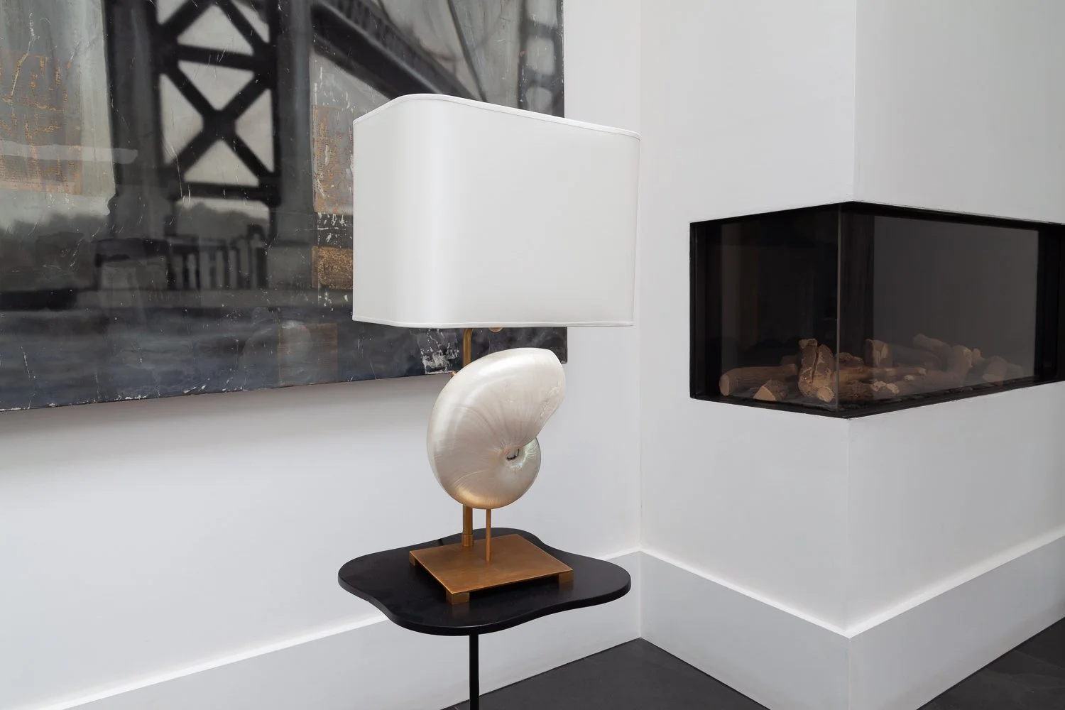 Isabelle Bizard Capri table lamp with a nautile shell, beside a fireplace, interior design photographer London
