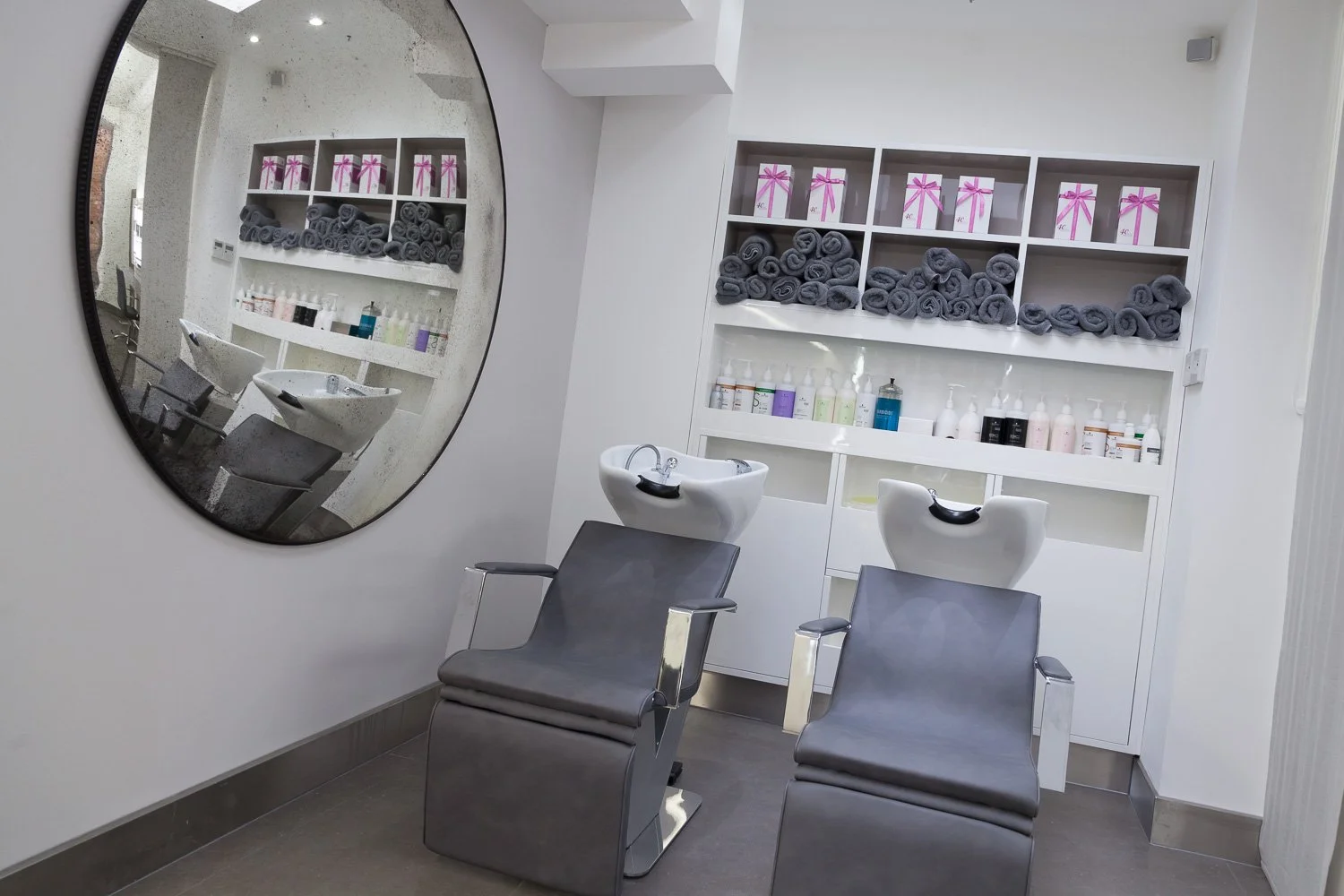 Alternate angle of the hair salon wash area with round mirrors, interior photographer