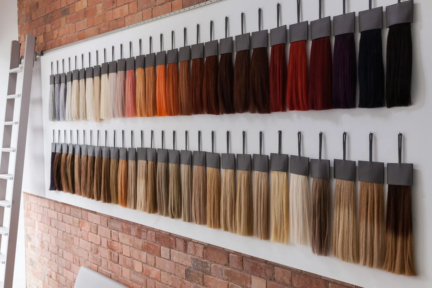 Close-up of hair colour swatch display against exposed brick wall, interior design photographer London
