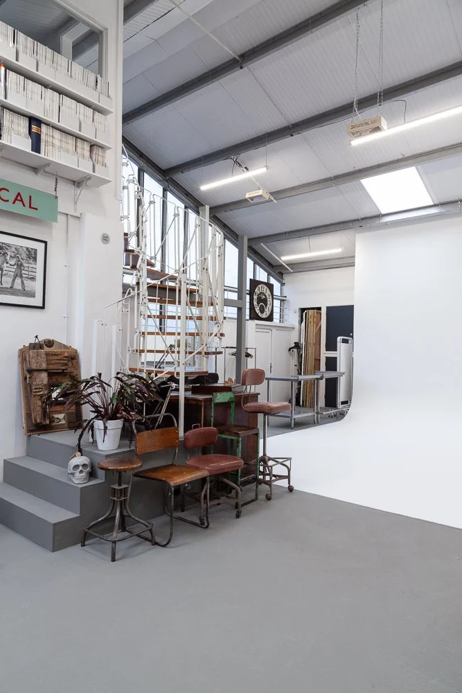 Photographic studio interior with staircase and vintage furniture props, interior photographer London, Essex
