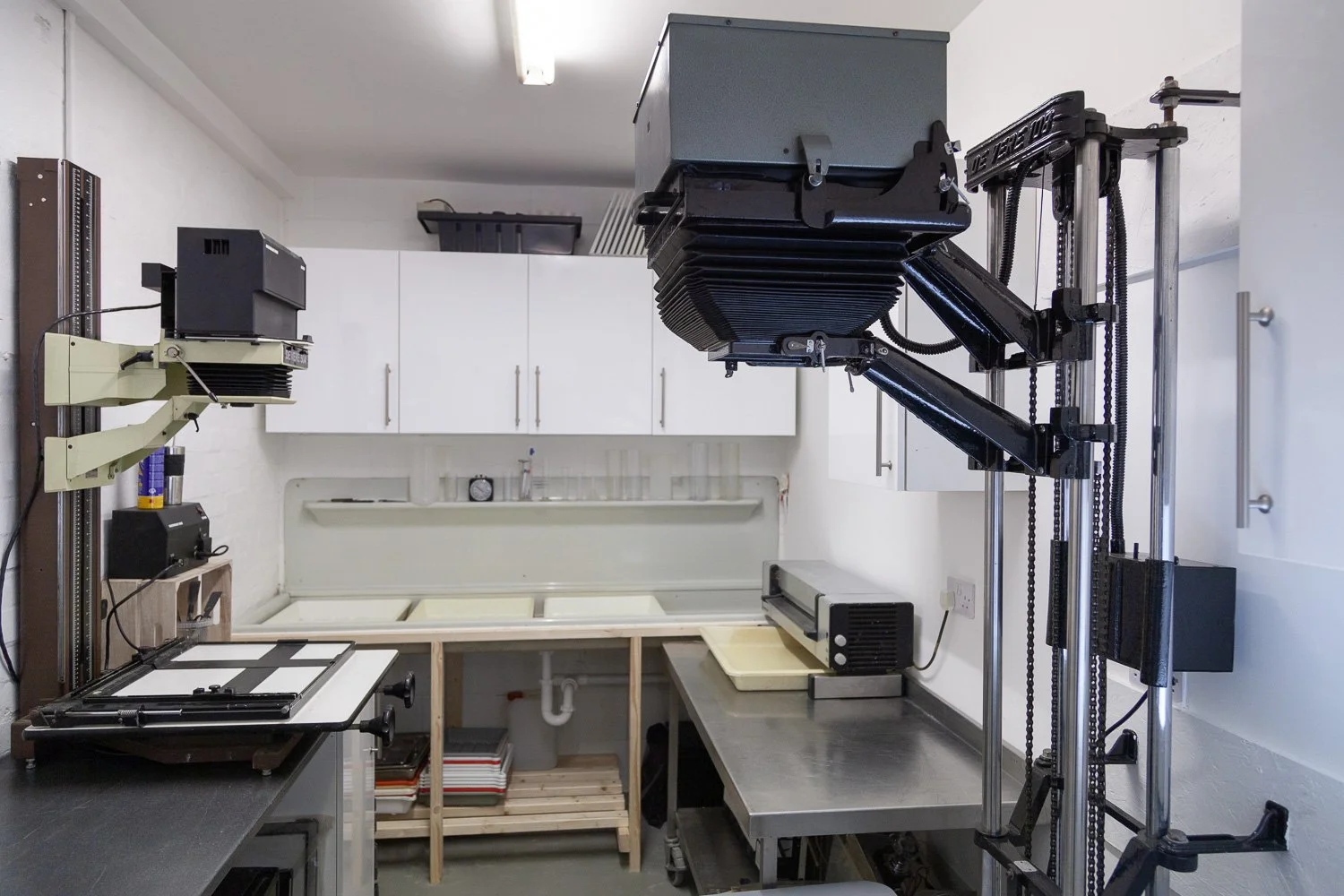 Wide view of photographic studio darkroom with multiple enlarger stations, interior design photography, Essex