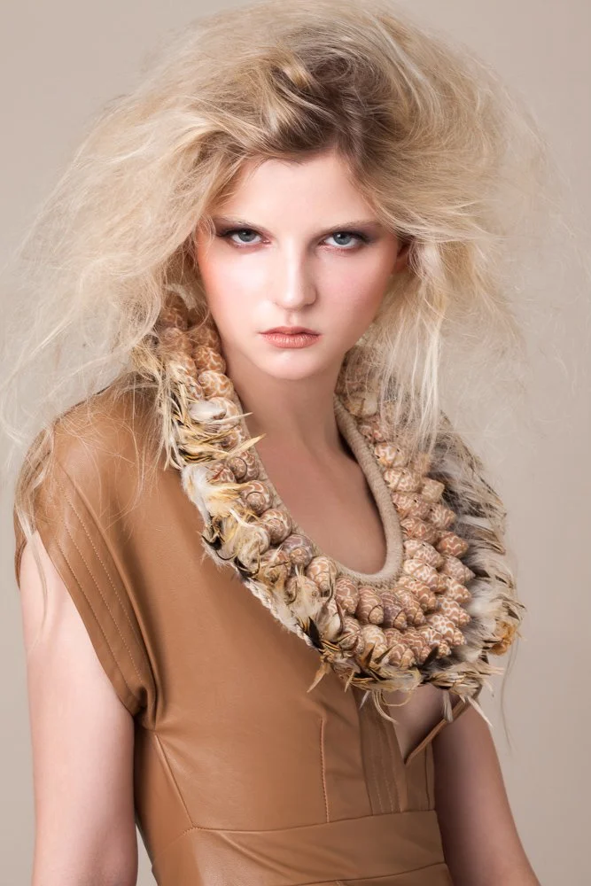 Model in a tan leather dress with a statement shell collar, styled and art directed by Laurence Trolet, fashion and editorial photography