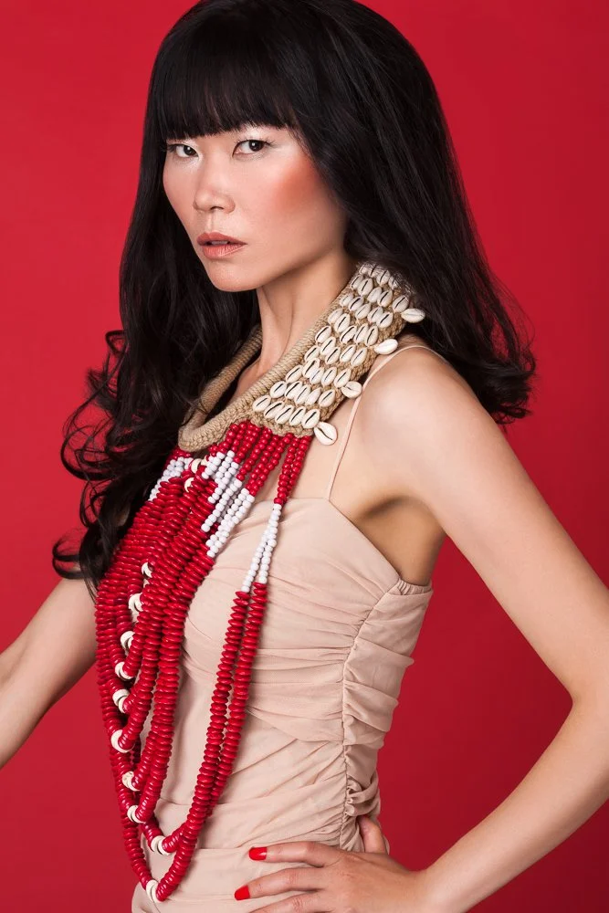 Model in a nude dress with a layered beaded necklace, styled and art directed by Laurence Trolet, fashion and editorial photography