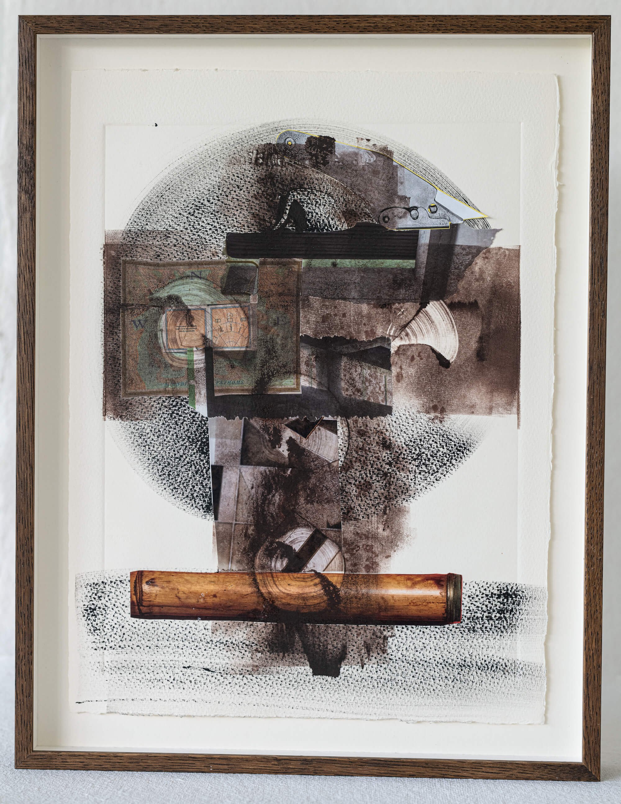 Framed abstract art with cylindrical shapes and textured layers