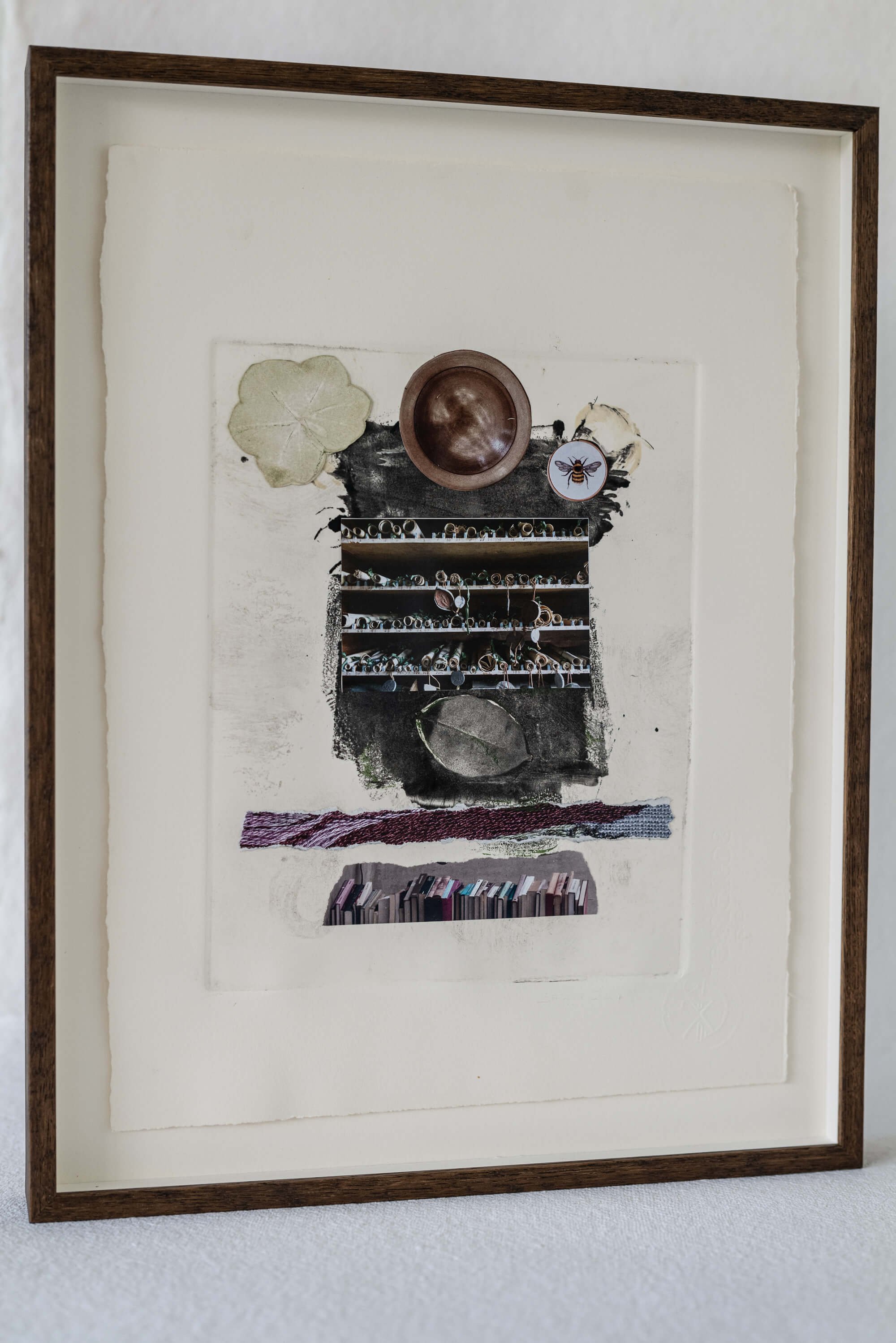 Framed abstract art with textured layers in earthy tones