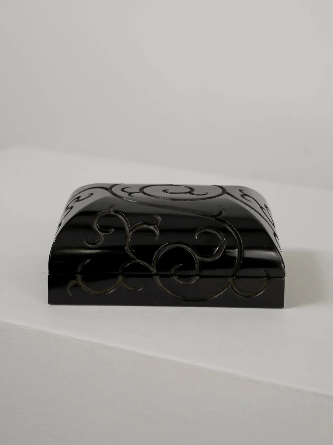 Carved lacquer box 
Relief scroll motif with black urushi finish

Japan, 20th century 

Artist mark &amp; original tomobako 

Available online