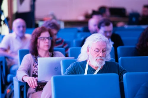 Concentrated Conference Attendee Working on Laptop