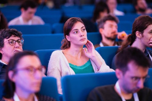 Focused Woman in Audience at European Event