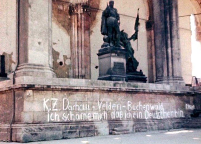 Picture of graffiti on a monument in Germany listing the names of concentration camps