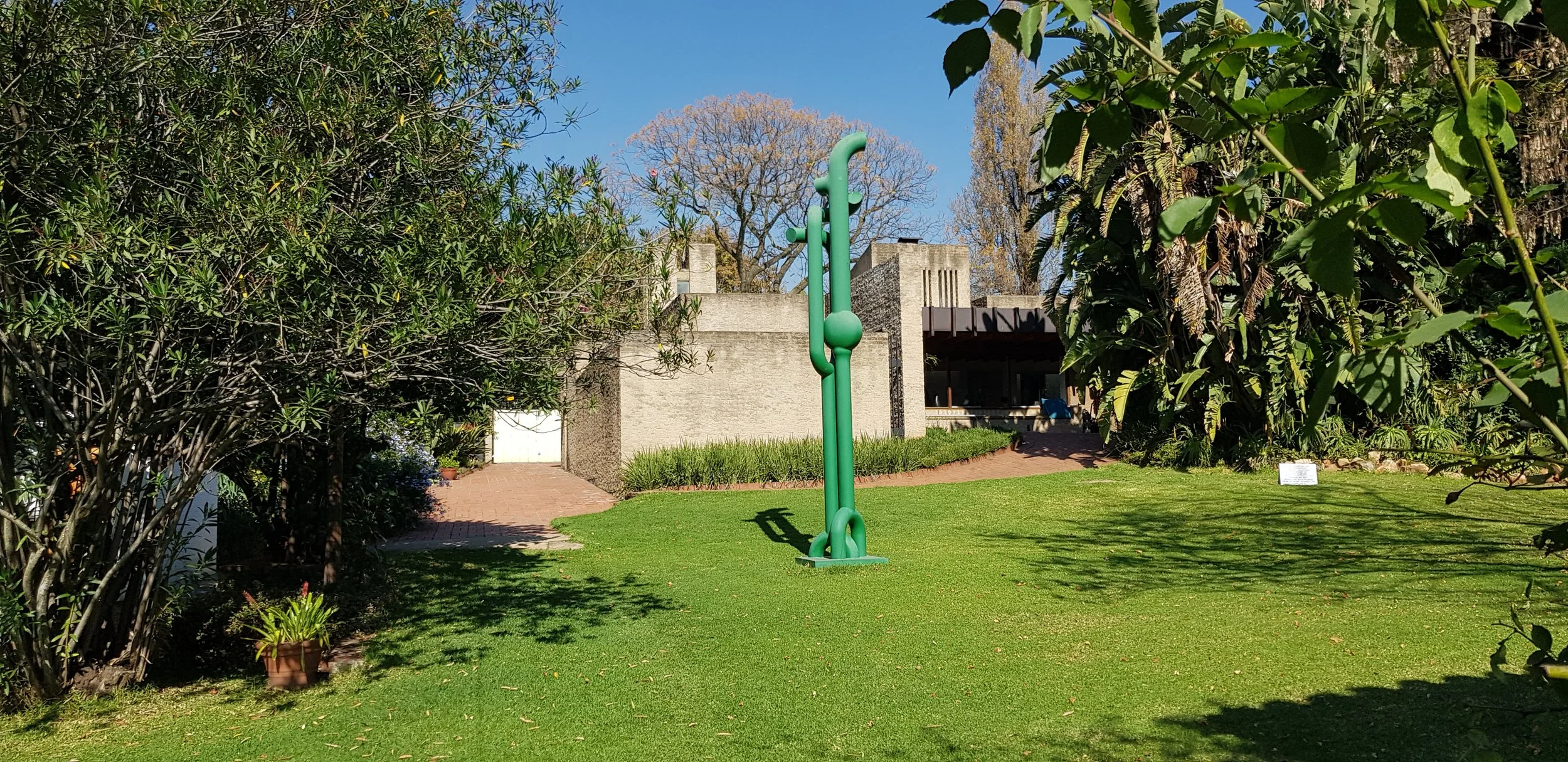 The garden at the Eduardo Villa house with a sculpture in joburg taken by architect Thorsten Deckler