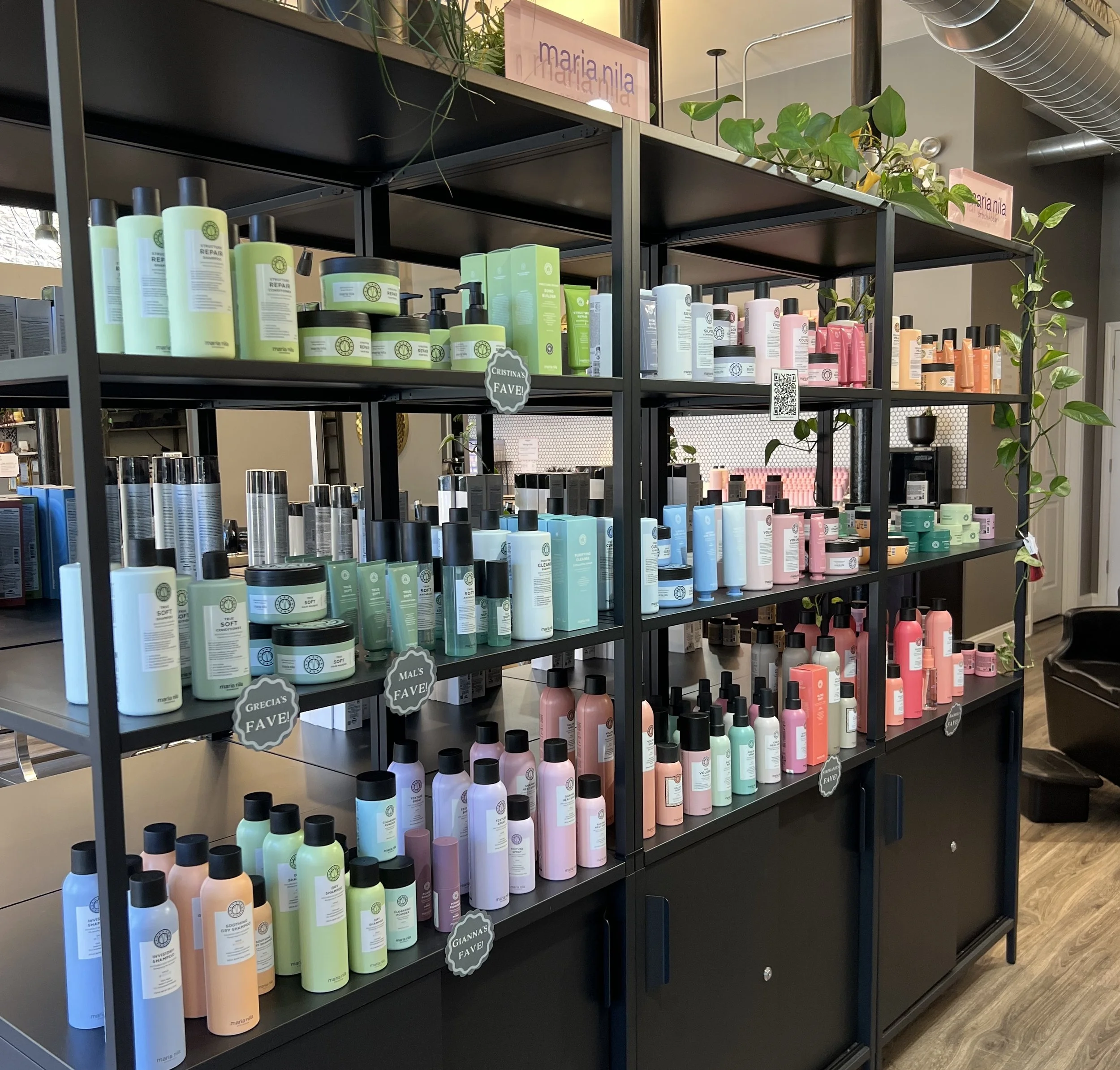 Maria Nila hair care products displayed on a retail shelf at The Gilded Lily Chicago salon, featuring vegan shampoos, conditioners, styling products, and hair treatments.