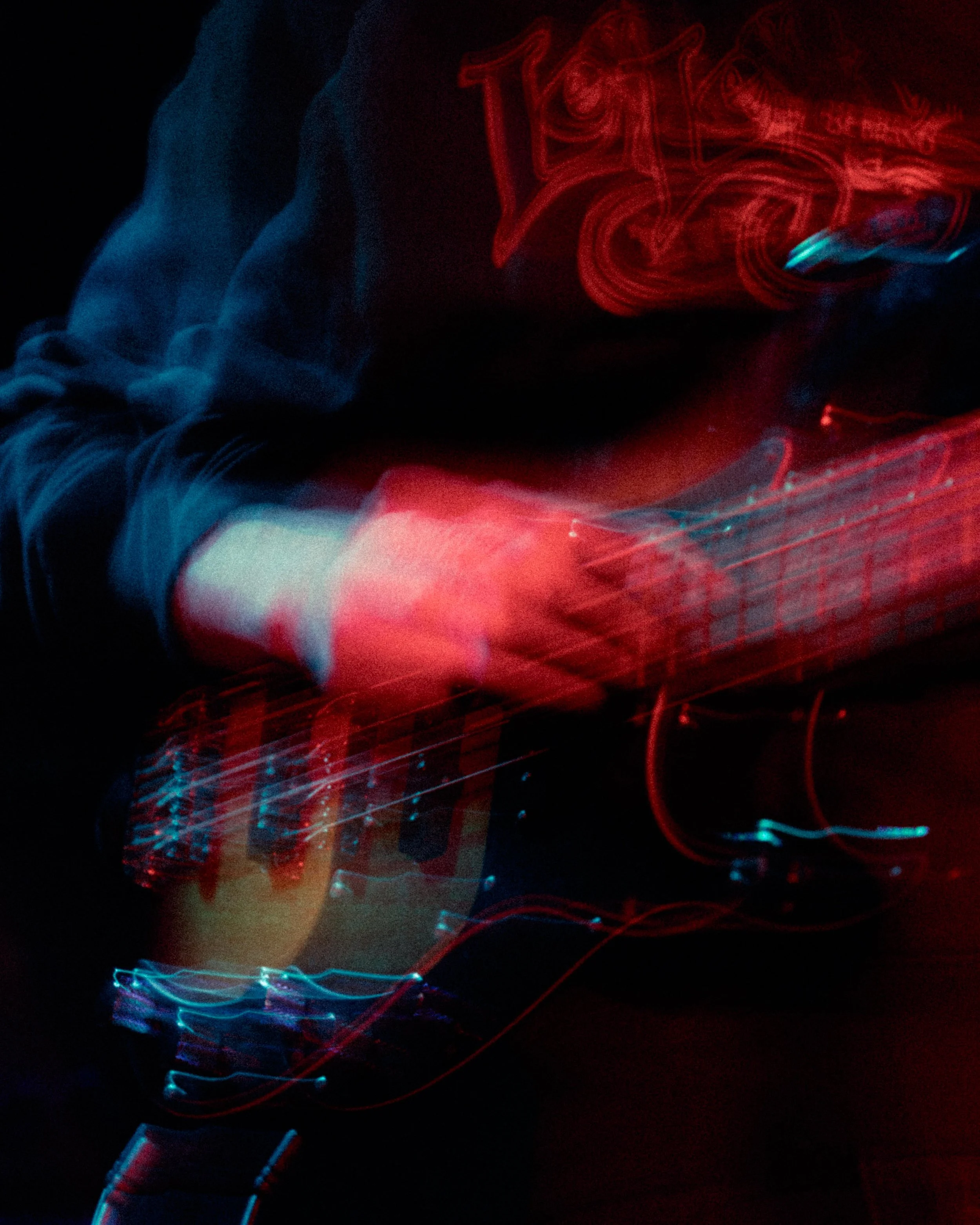 Abstract neon light painting with red and blue streaks and curves on a dark background.