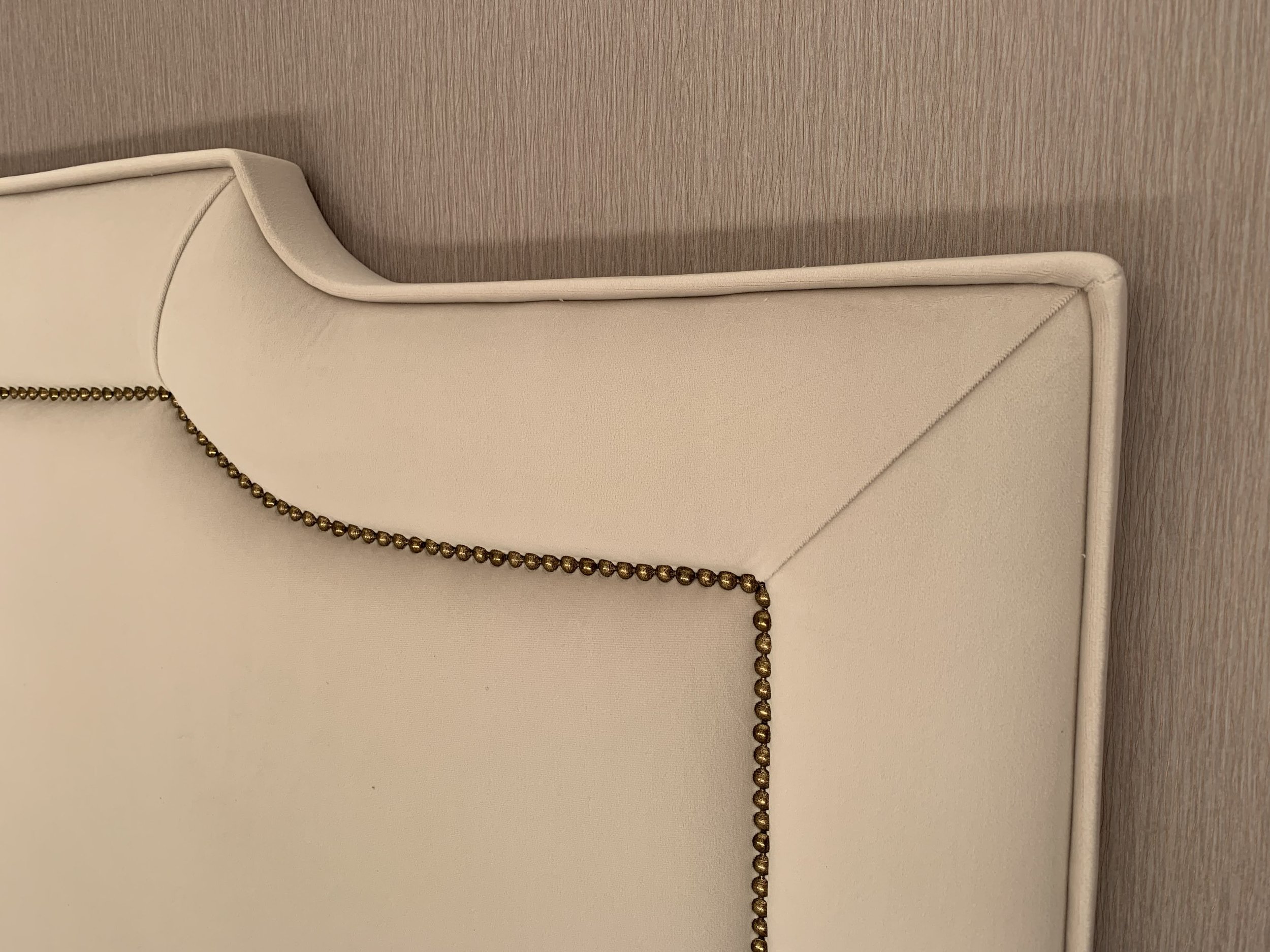 Ivory handmade headboard against blush wallpaper by Bobby Lardner.JPG