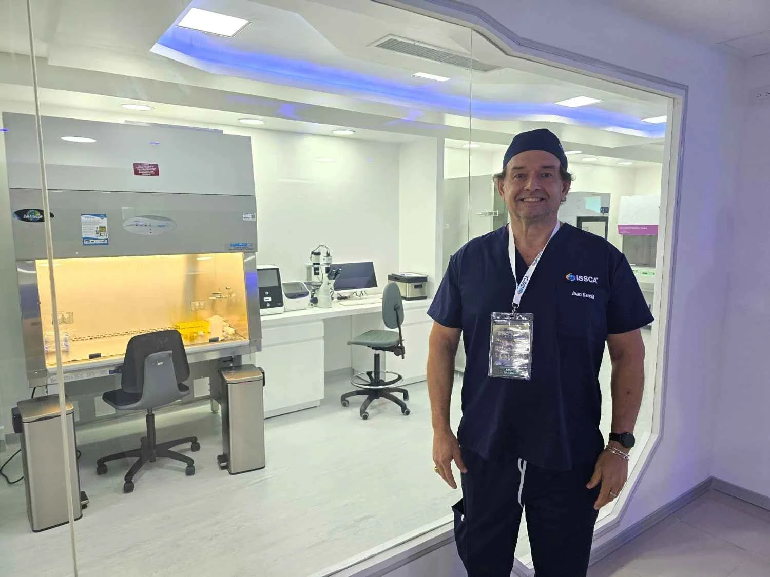Dr. Juan Garcia, MD, Chief Medical Officer at Huemn, standing in front of a regenerative medicine laboratory in Houston.