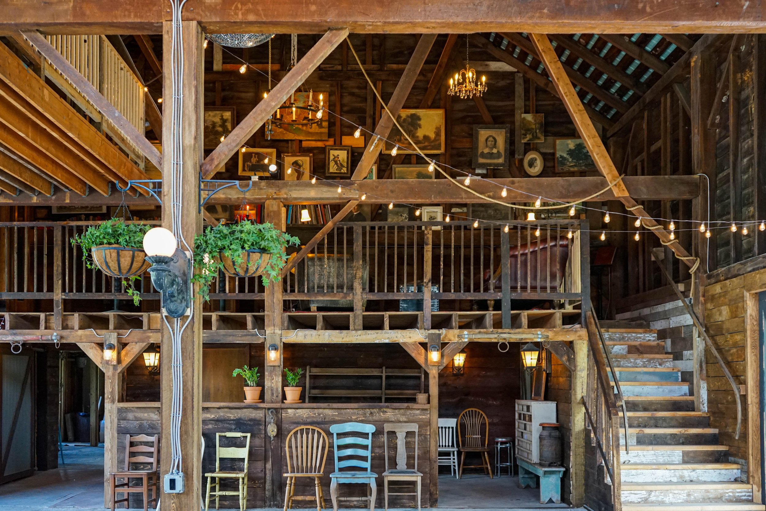 A wide shot of the mezzanine and soaring ceilings of a barn in the Catskills wedding venue Black Walnut Farm