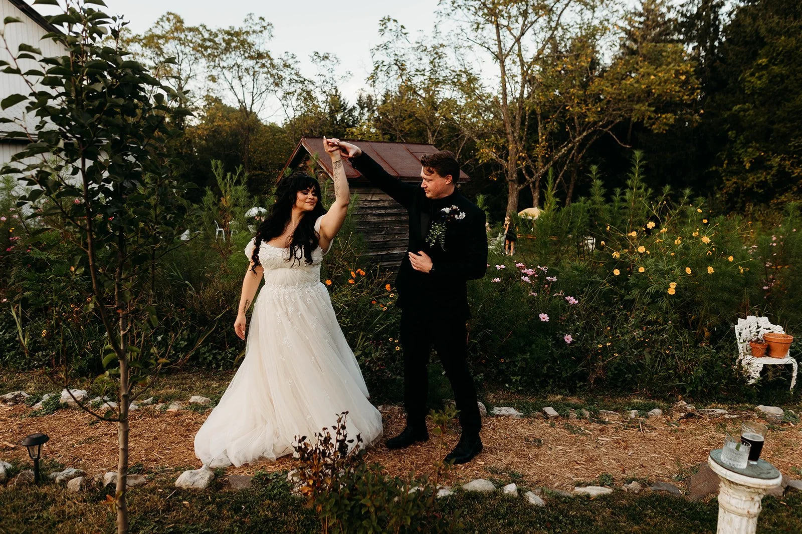 A bride and groom dance through a wildflower path at Catskills wedding venue black walnut farm
