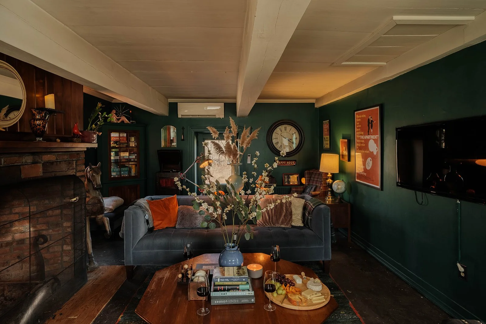 a cozy living room with velvet sofas and a fireplace
