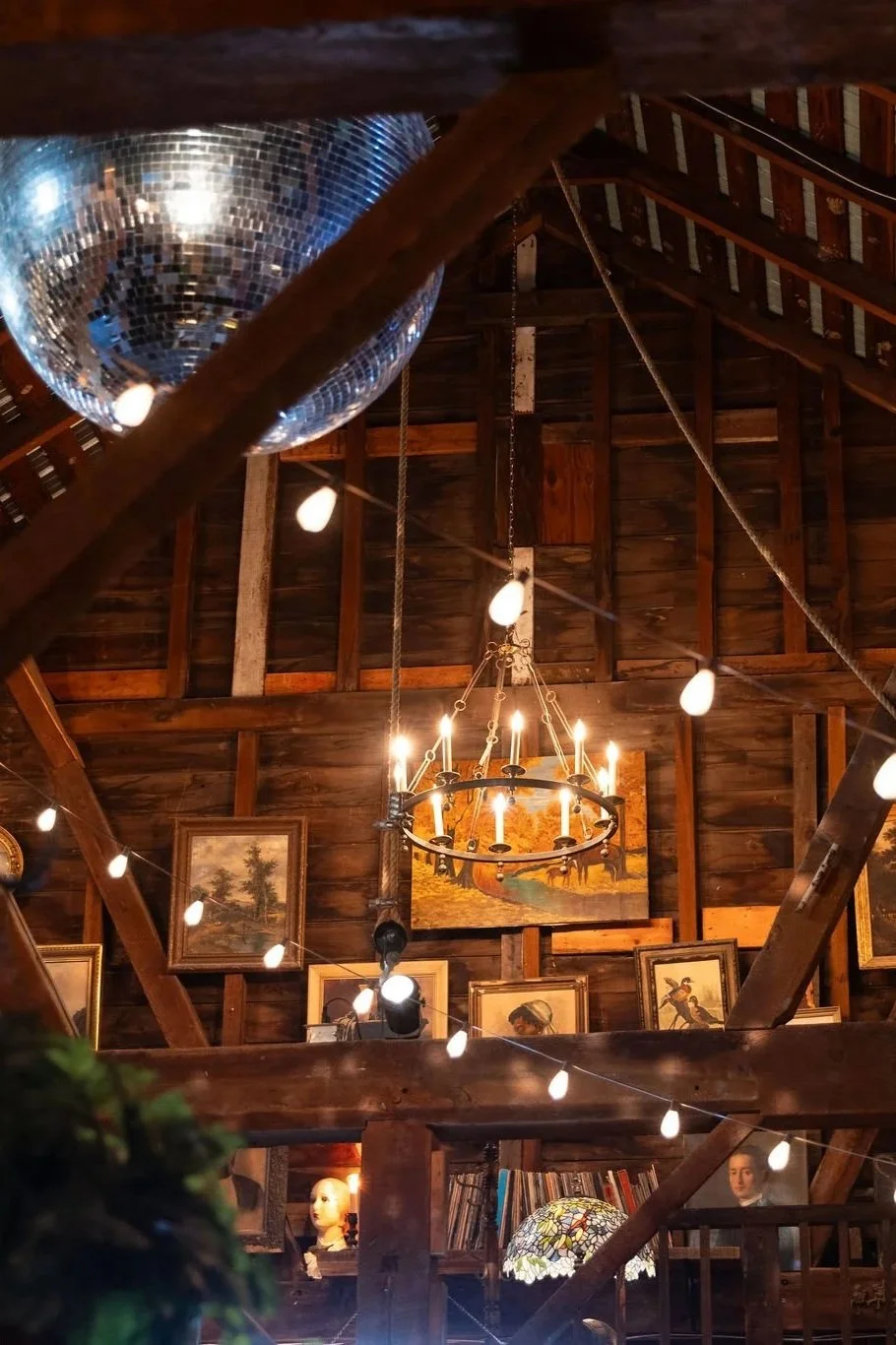 Chandeliers, strings lights and sconces in a rustic barn at Black Walnut Farn 