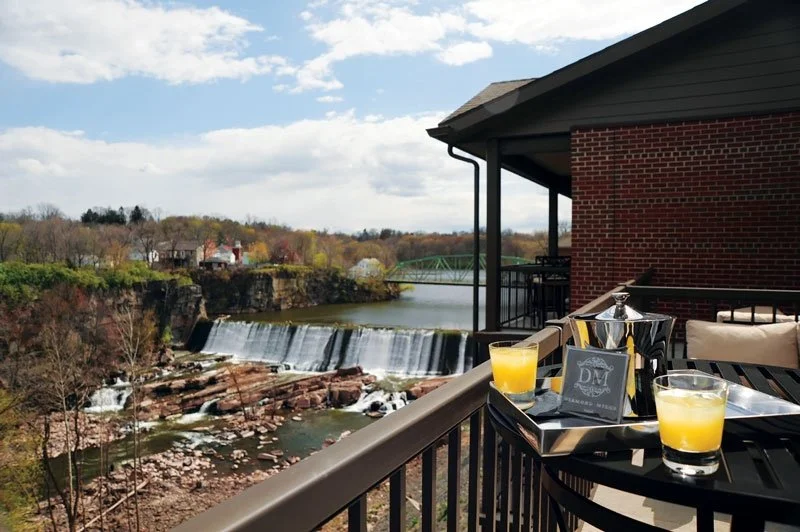 hotel balcony with a waterfall in the background.