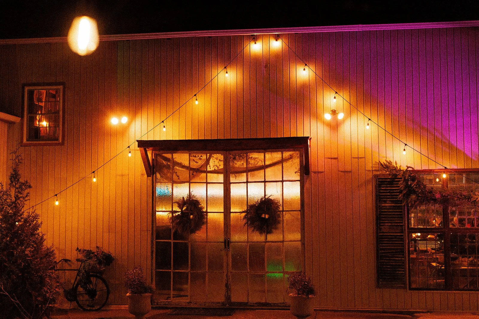 a cosy glowy shot of glass barn doors and colorful lights.
